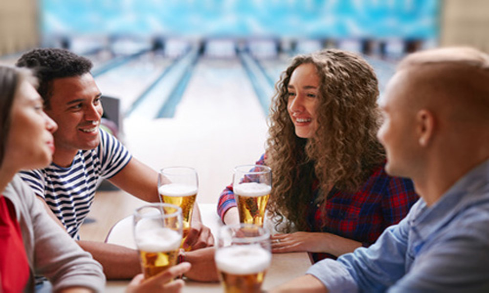 couple bowling with beer